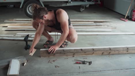 Woodworker-Uses-F-clamps-To-Join-Wood-Planks-For-Gluing-And-Drilling