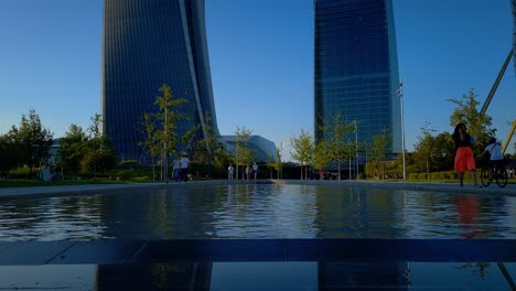 Urban-living-redefined:-CityLife-Park,-Milan,-reflect-towers-in-the-fountain-below-them