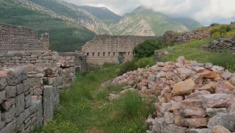 Walking-inside-old-fortress-and-ruins-with-mountains-background,-point-of-view