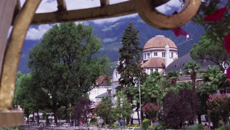 Zooming-out-on-the-famous-Kurhaus-with-its-promenade-in-the-city-center-of-Meran--Merano,-South-Tyrol,-Italy