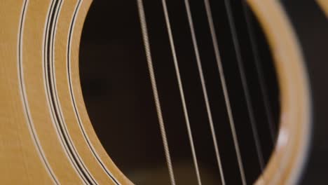 Plucking-the-strings-of-a-guitar-while-filming-in-slow-motion