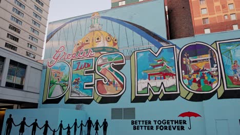Greater-Des-Moines,-Iowa-mural-in-downtown-Des-Moines-with-gimbal-video-panning-left-to-right