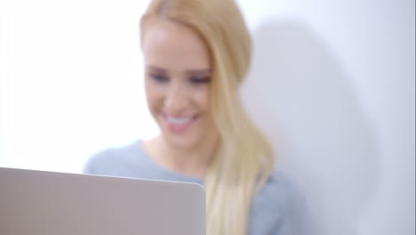 Blurred-Woman-Using-her-Laptop-Computer