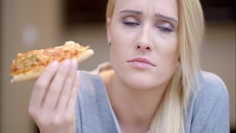 Attractive-woman-eating-homemade-pizza