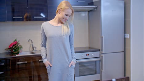 Lächelnde-Blonde-Frau-Posiert-In-Der-Küche