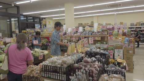 Japanese-People-Buy-Groceries-Inside-a-Local-Supermarket-in-Kyoto-Pale-Colors-Shot