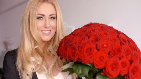 Happy-Woman-with-Fresh-Red-Rose-Flower-Bouquet