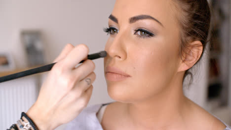 Makeup-Artist-Applying-Blush-to-a-Pretty-Woman