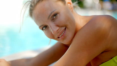 Blond-Woman-Smiling-at-Camera-by-Swimming-Pool