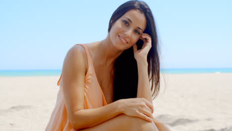 Attractive-Young-Lady-Relaxing-at-the-Beach-Sand