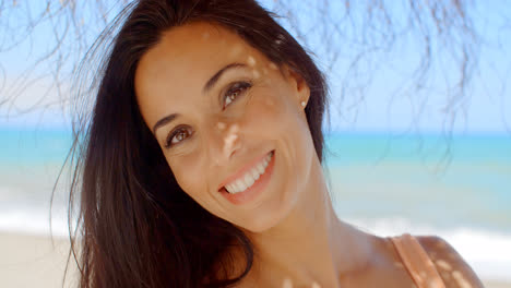 Cheerful-Woman-at-the-Beach-Smiling-at-Camera