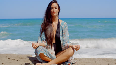 Pretty-Young-Woman-Doing-Yoga-at-the-Beach