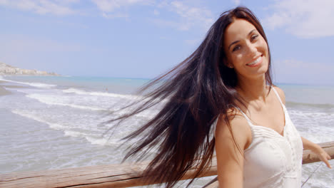 Happy-Woman-at-the-Railing-with-Air-Blown-Hair