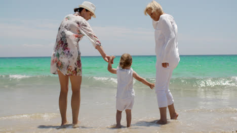 Grandmom--Mom-and-Little-Girl-Playing-at-the-Beach