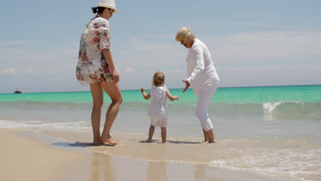 Girl-Enjoying-at-the-Beach-with-Mom-and-Grandma