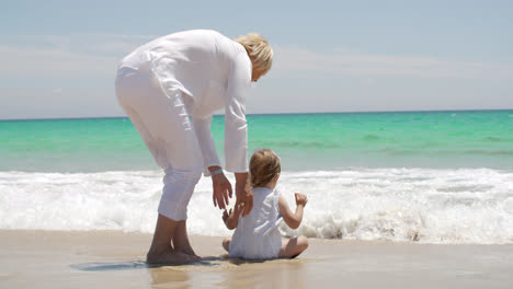 Mom-and-Little-Girl-Enjoying-Beach-Water-Splash