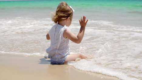 Cute-Baby-Girl-Sitting-on-the-Beach