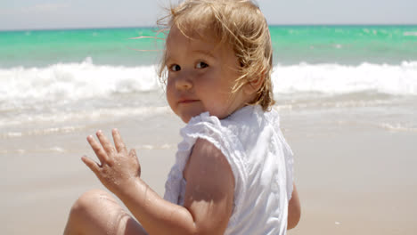 Cute-little-blond-girl-enjoying-the-beach
