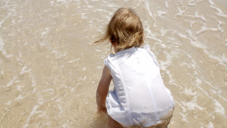 Little-girl-paddling-in-shallow-surf
