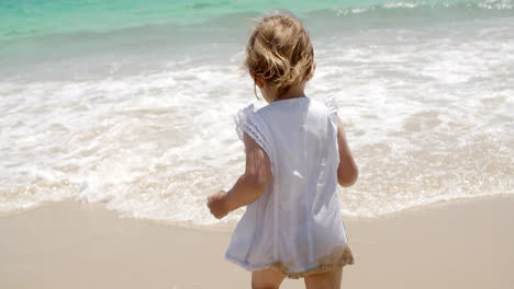 Little-Blond-Girl-Enjoying-at-the-Beach-on-Summer