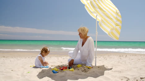 Cute-Girl-and-Grandmother-Playing-on-the-Beach