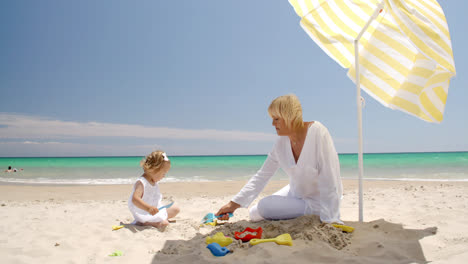 Little-girl-playing-with-her-granny-on-the-beach