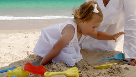 Cute-Young-Girl-Playing-in-Sand