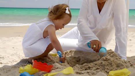 Little-girl-digging-in-golden-beach-sand
