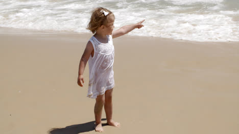 Cute-little-girl-pointing-out-to-sea