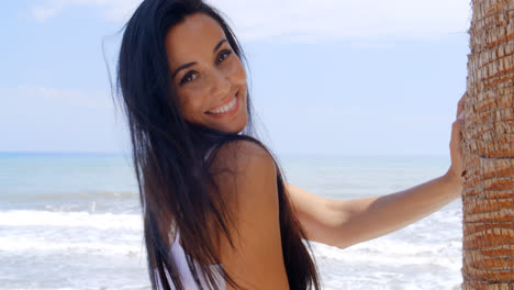 Woman-at-the-Beach-Smiling-Over-her-Shoulder
