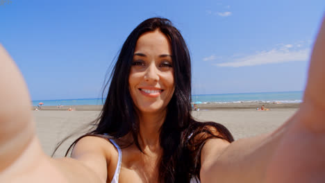 Brunette-Woman-Taking-Self-Portrait-on-Beach