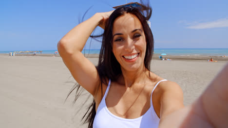 Smiling-Woman-Taking-Self-Portrait-on-Windy-Beach