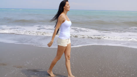 Woman-Walking-Along-Shore-of-Tropical-Beach