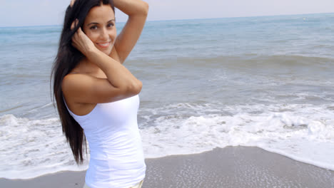 Woman-Walking-on-Beach-and-Smiling-at-Camera