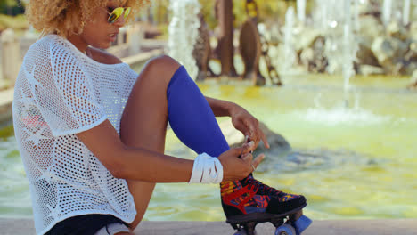 Girl-Tying-Shoelaces-in-Her-Roller-Skates