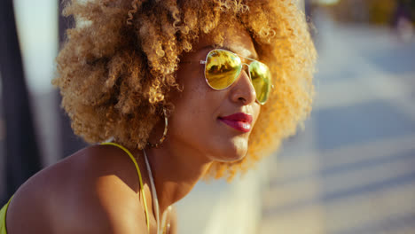 Smiling-Girl-with-Afro-Resting-on-Promenade