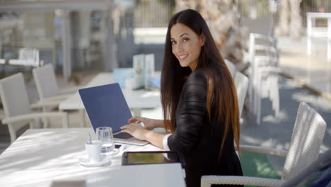 Elegant-businesswoman-working-on-a-laptop