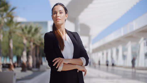 Thoughtful-businesswoman-with-folded-arms