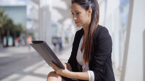 Attractive-businesswoman-working-on-a-tablet