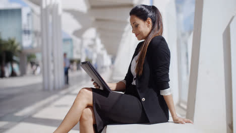 Elegant-business-manageress-working-on-a-laptop