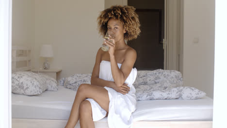 Girl-Drinking-Fresh-Water-On-The-Bed