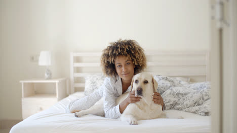 Woman-Is-Holding-A-Dog-On-A-Bed