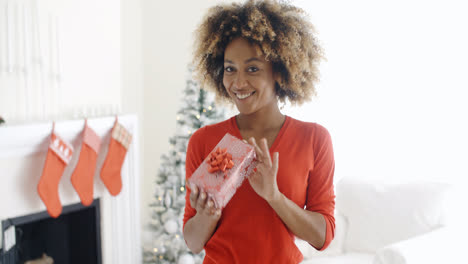 Smiling-African-woman-holding-a-Christmas-gift