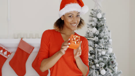 Lovely-young-woman-holding-a-Christmas-gift