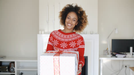 Happy-Smiling-Girl-With-Afro-Haircut-Holding-Gift