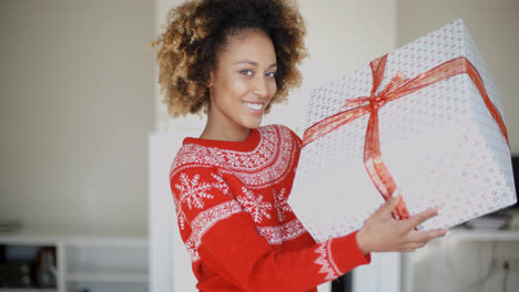 Happy-Smiling-Girl-With-Afro-Haircut-Holding-Gift