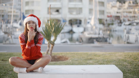 Sexy-Girl-Sitting-on-a-Bench-in-Santa-Hat