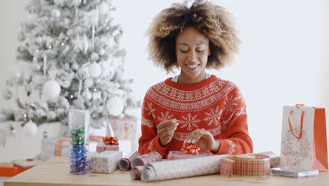 Happy-young-African-woman-wrapping-presents