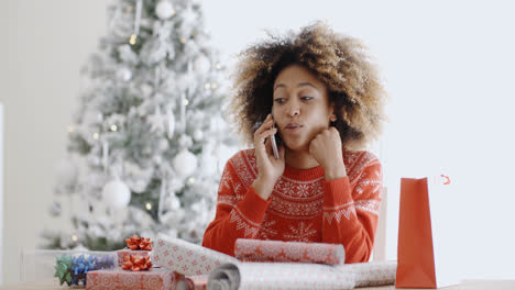 Young-woman-chatting-on-her-mobile-at-Christmas