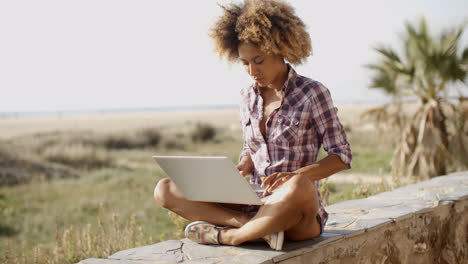 Girl-Working-With-A-Laptop-Outdoors